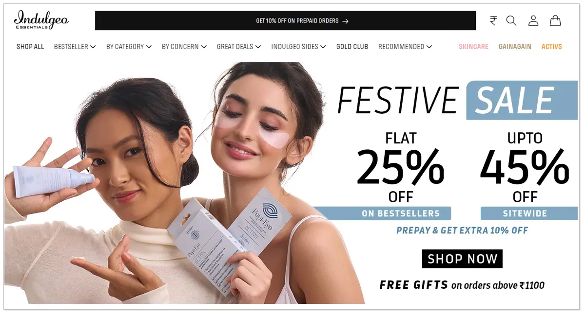 Home page of Indulgeo Essential with two girls applying the beauty products with festive sale and shop now button.