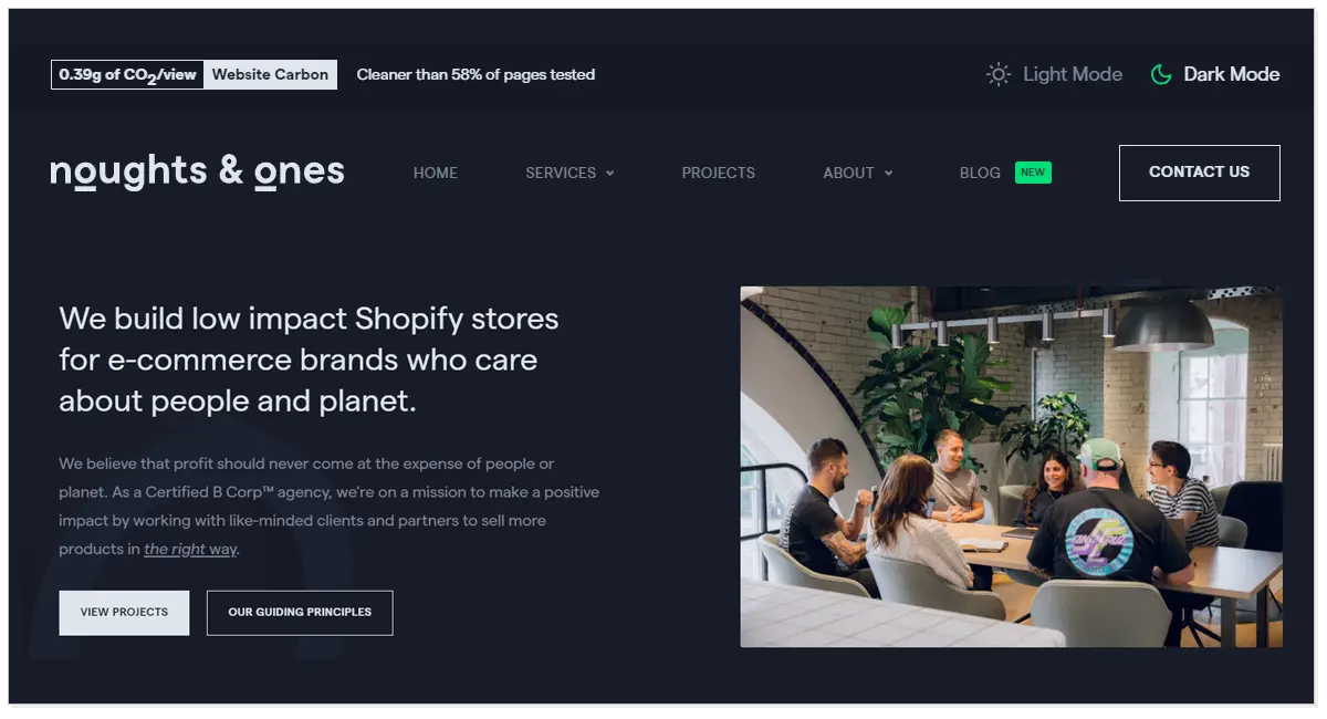 A home page of Noughts & Ones Marketing Agency with the picture of a team sitting together and discussing on a matter.