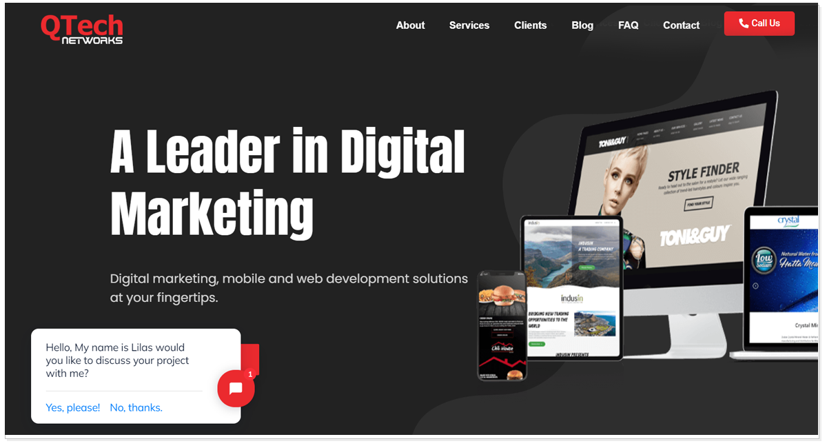 QTech Networks home page with the pictures of monitors and mobile screen and a pop up message of customer chat box.
