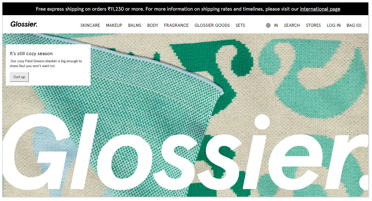 Home page of Glossier, with a popup message saying it's still cozy season.