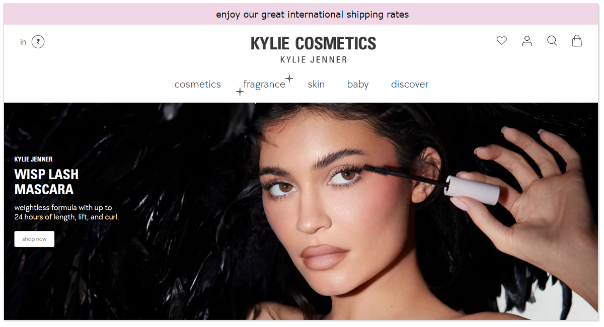 Kylie Cosmetic with a picture of a girl applying beauty product and shop now..