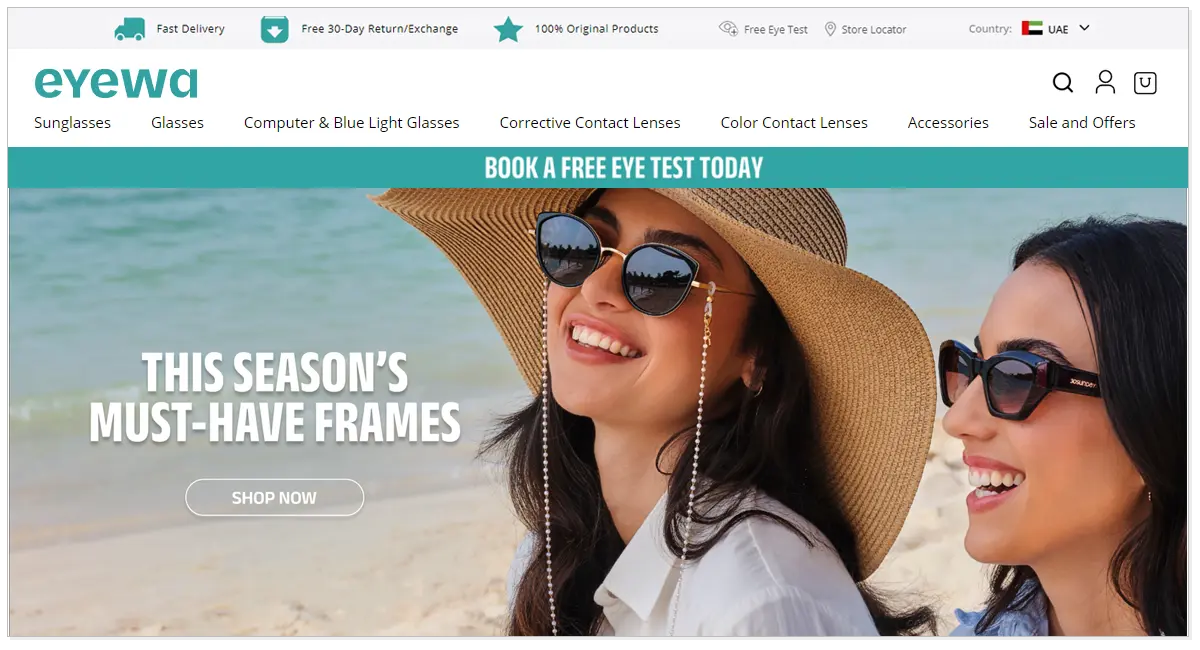 Home page of Eyewa with Shop Now button and two girls wearing eyeglasses and smiling next to the sea.